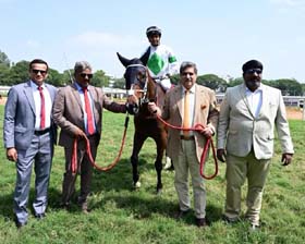 Money Bags ( Vivek up), winner of BTC Anniversary Cup being led in by Manoj Kumar, trainer Prasanna Kumar and Capt Jamshed J Appoo at Bangalore on Sunday.